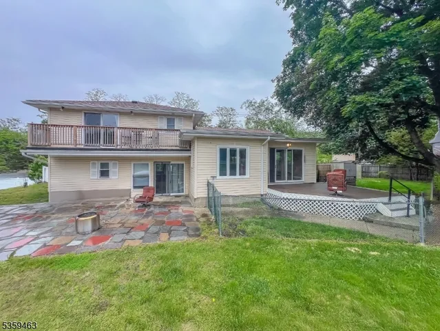 a front view of house with yard and outdoor seating
