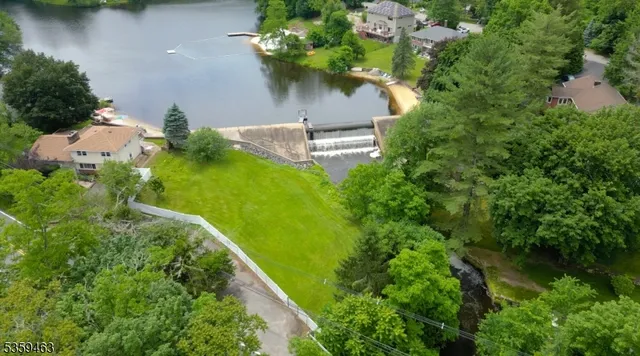 an aerial view of a house with a yard lake house and outdoor seating