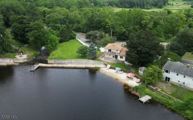 an aerial view of a house with a yard basket ball court and outdoor seating