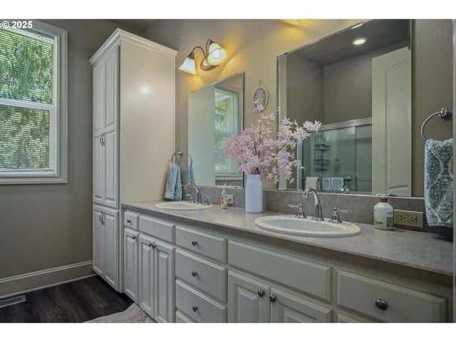 a bathroom with a double vanity sink and a mirror