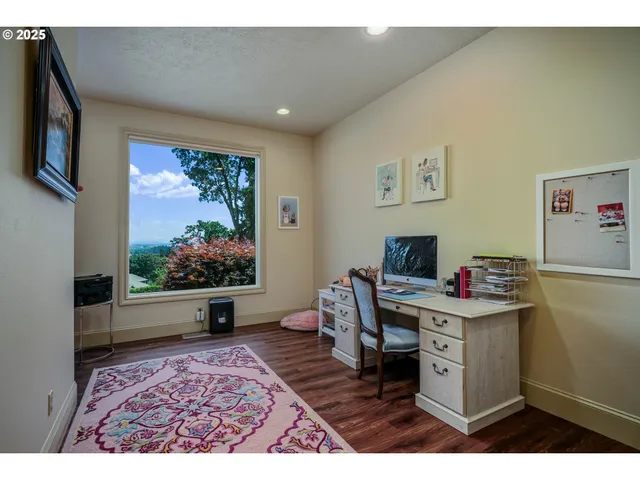 a view of a workspace with furniture and a flat screen tv