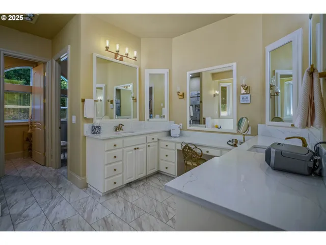 a bathroom with a granite countertop sink a large mirror and a