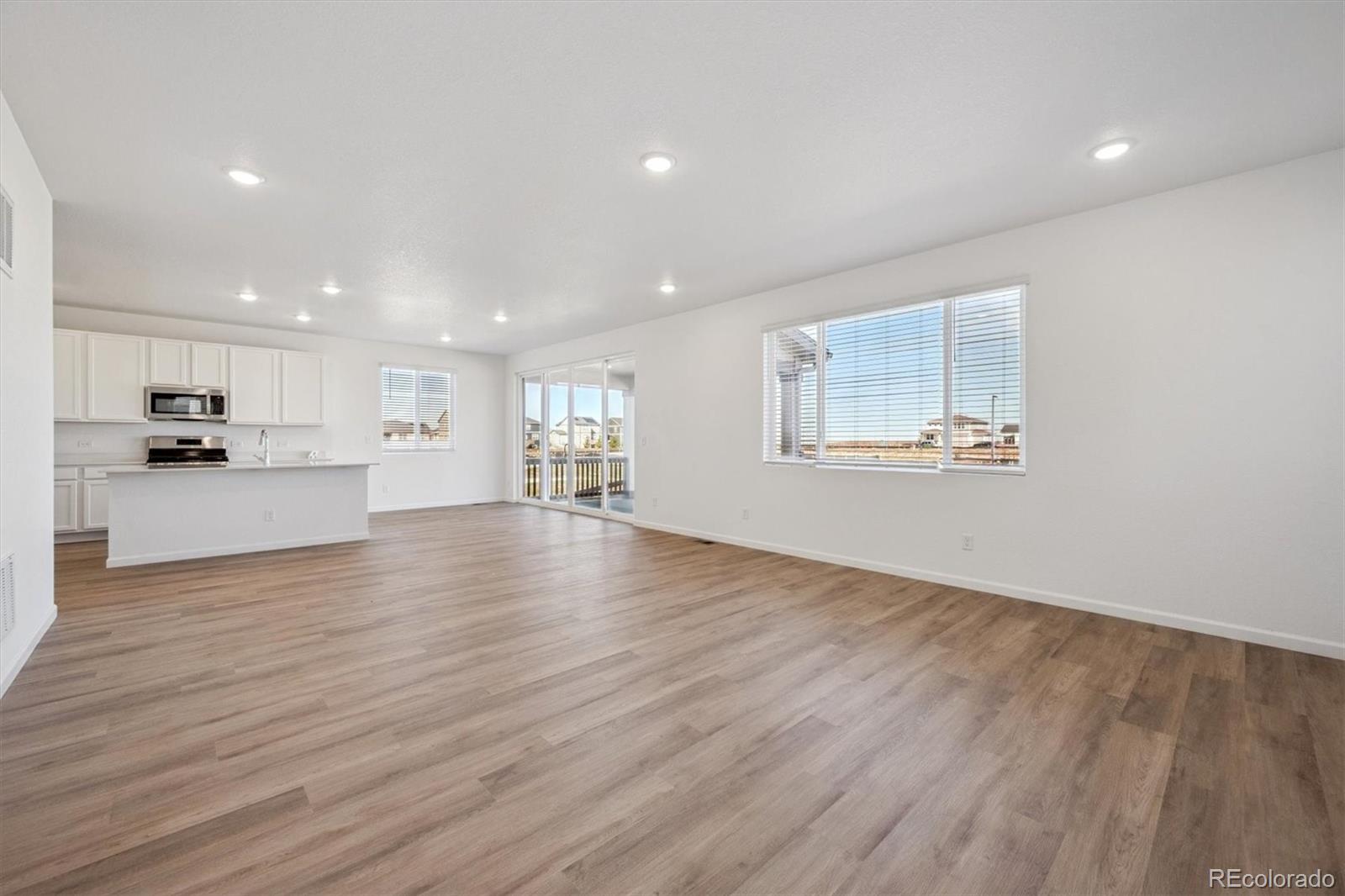 45929 Gentry Avenue Bennett, CO 80102 - Photo 11 of 24 a view of an empty room with wooden floor and a window