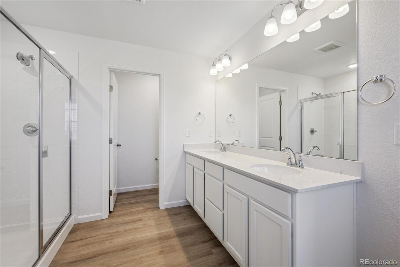 45929 Gentry Avenue Bennett, CO 80102 - Photo 15 of 24 a bathroom with a double vanity sink mirror and shower