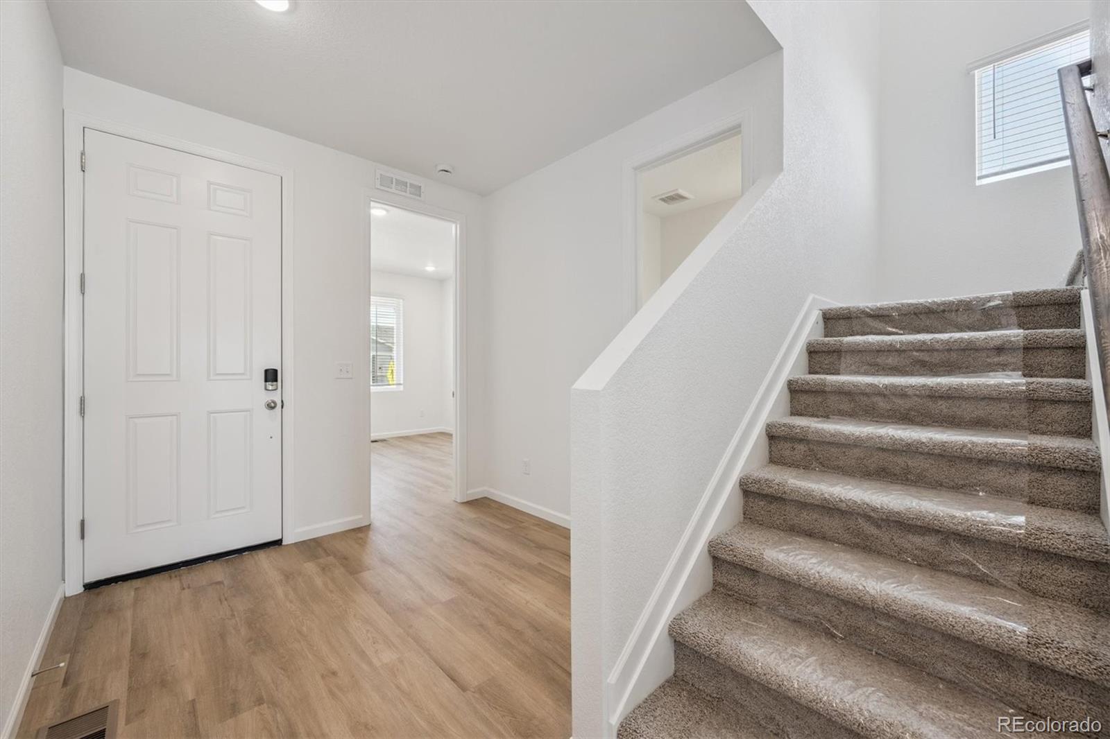 45929 Gentry Avenue Bennett, CO 80102 - Photo 3 of 24 a view of an entryway with wooden floor