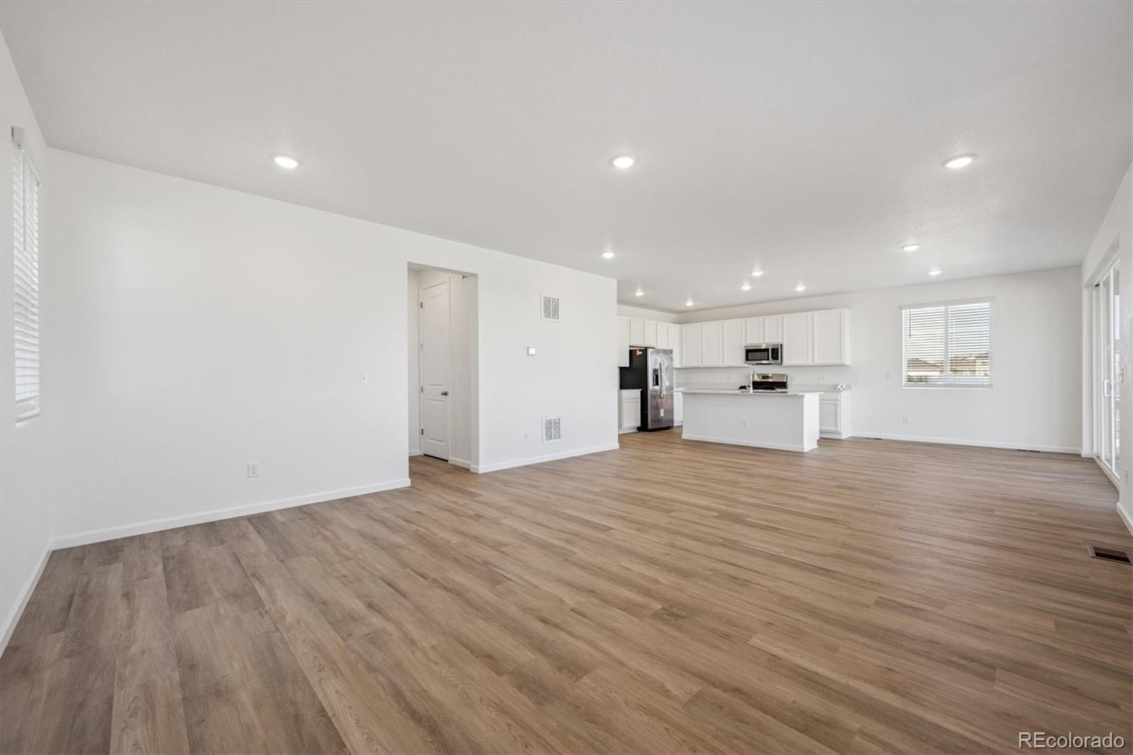 45929 Gentry Avenue Bennett, CO 80102 - Photo 10 of 24 a view of empty room with wooden floor