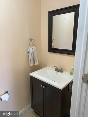 a bathroom with a sink vanity and mirror
