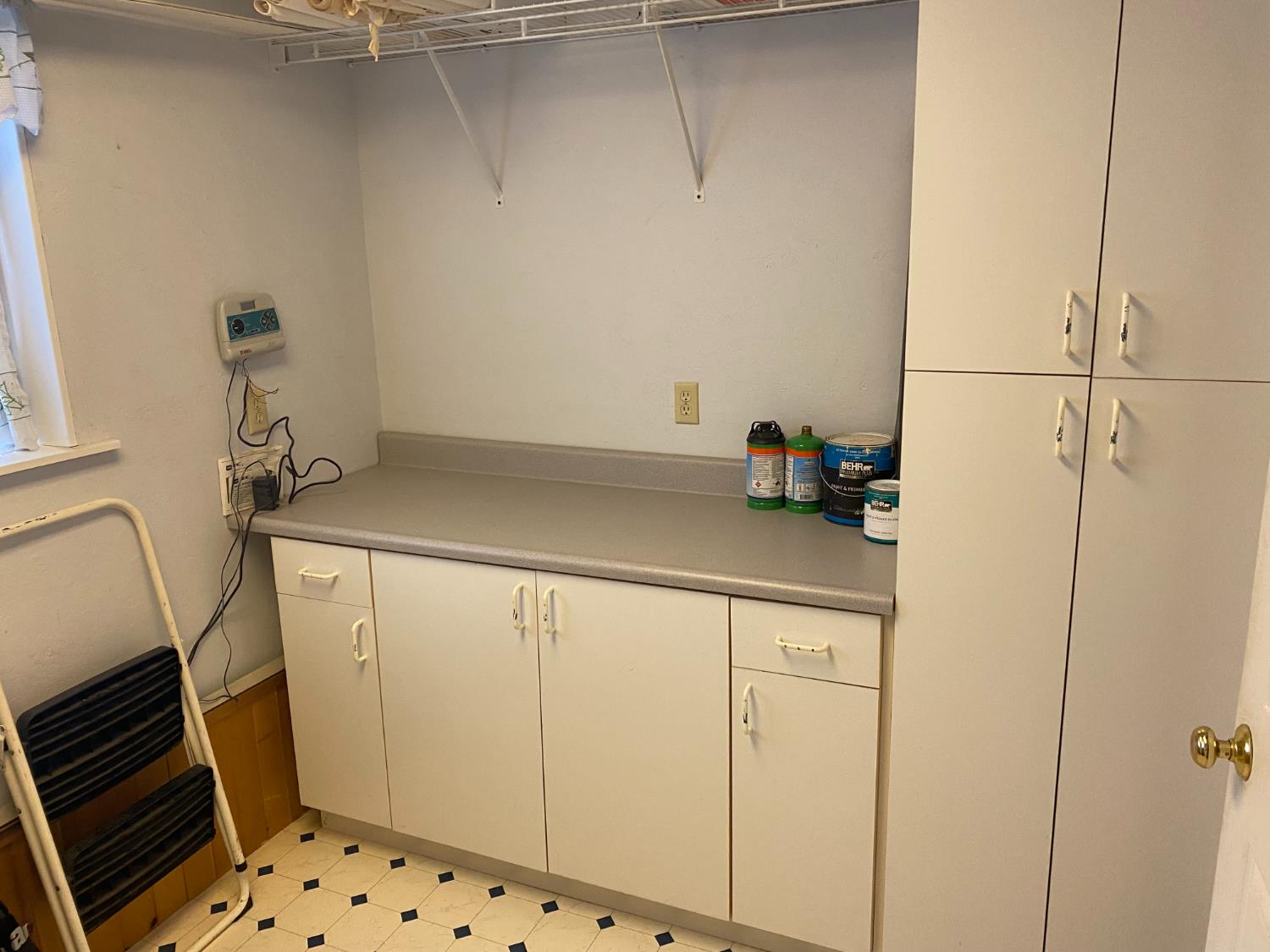 5021 Banbury Cross Road Shingle Springs, CA 95682 - Photo 45 of 92 The other side of the laundry room has a hanging rack, counter with storage cabinets and tall storage.