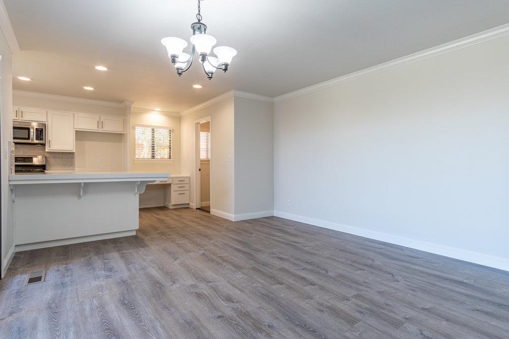 1220 Heather Glen Circle Hollister, CA 95023 - Photo 12 of 41 a view of a kitchen with a dishwasher cabinets and wooden floor