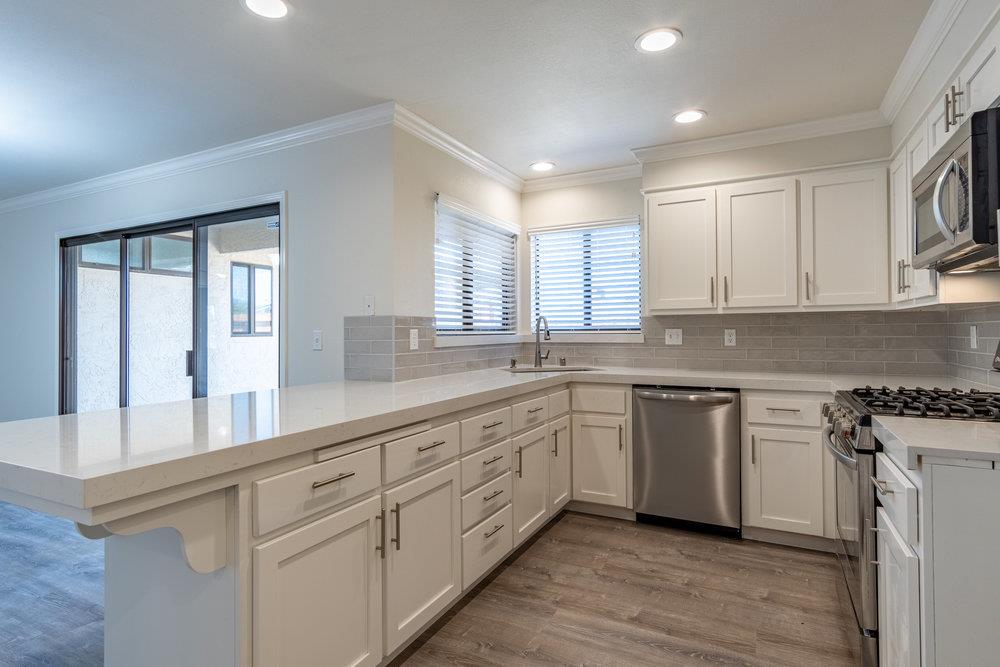 1220 Heather Glen Circle Hollister, CA 95023 - Photo 16 of 41 a kitchen with granite countertop white cabinets and white appliances
