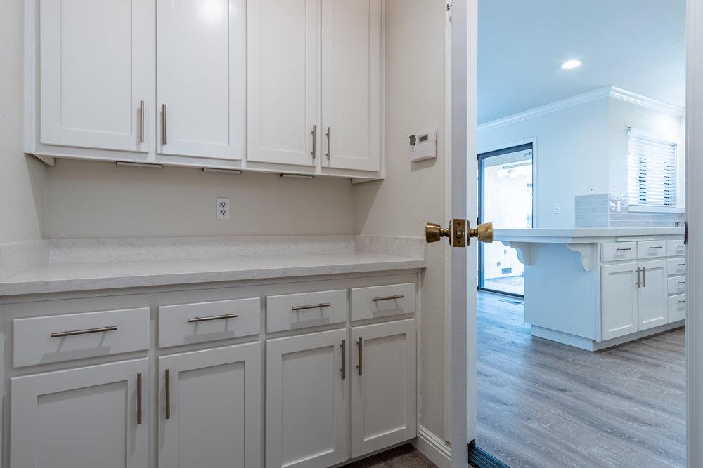 1220 Heather Glen Circle Hollister, CA 95023 - Photo 22 of 41 a kitchen with white cabinets and white appliances