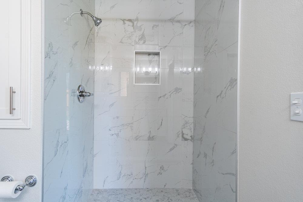 1220 Heather Glen Circle Hollister, CA 95023 - Photo 28 of 41 a bathroom with a glass shower door