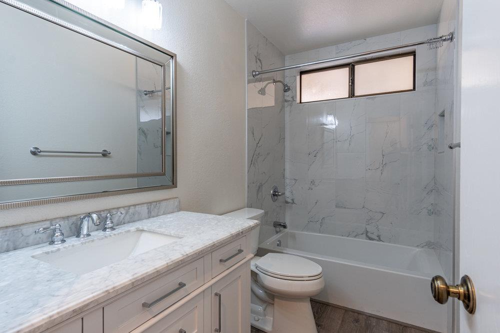1220 Heather Glen Circle Hollister, CA 95023 - Photo 35 of 41 a bathroom with a granite countertop sink a toilet and shower