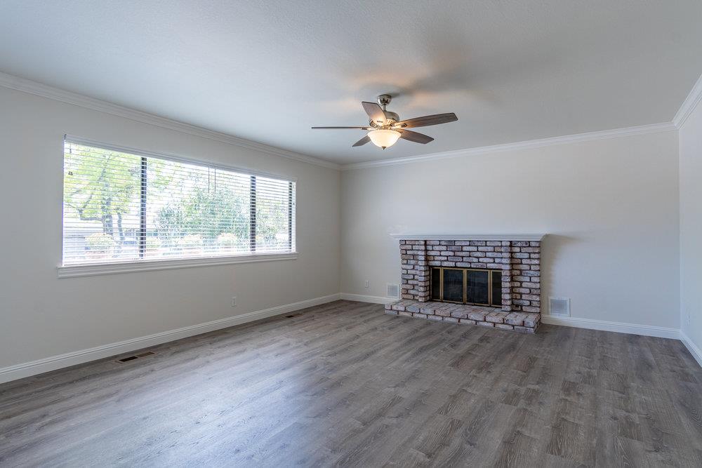 1220 Heather Glen Circle Hollister, CA 95023 - Photo 6 of 41 a view of an empty room with a window and fireplace