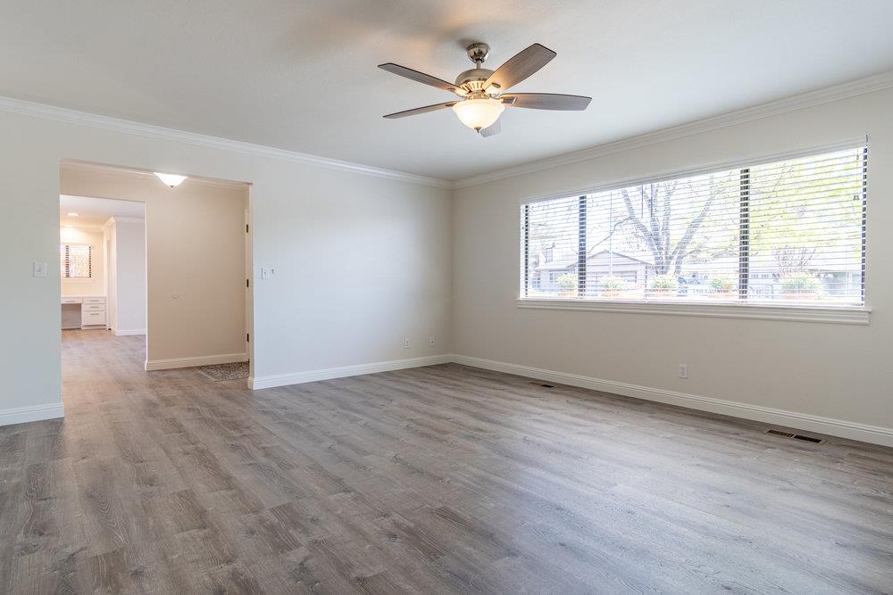 1220 Heather Glen Circle Hollister, CA 95023 - Photo 9 of 41 a view of an empty room with a window and wooden floor
