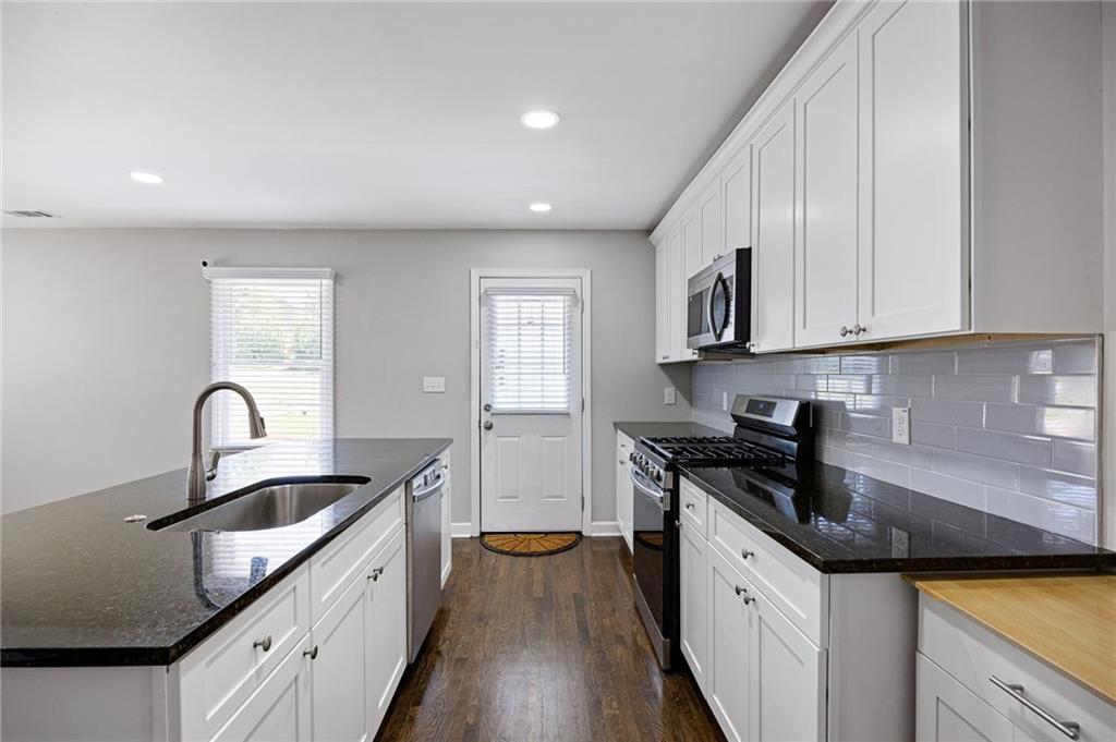 45 Smyrna Powder Springs Road Southeast Marietta, GA 30060 - Photo 11 of 45 a kitchen with granite countertop a sink and cabinets