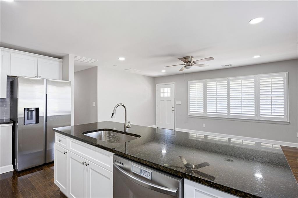 45 Smyrna Powder Springs Road Southeast Marietta, GA 30060 - Photo 13 of 45 a kitchen with granite countertop a sink stainless steel appliances and a counter space