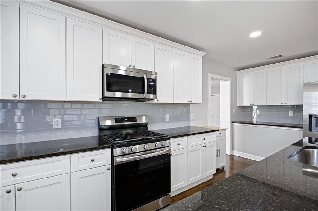 45 Smyrna Powder Springs Road Southeast Marietta, GA 30060 - Photo 14 of 45 a kitchen with cabinets stainless steel appliances and a sink