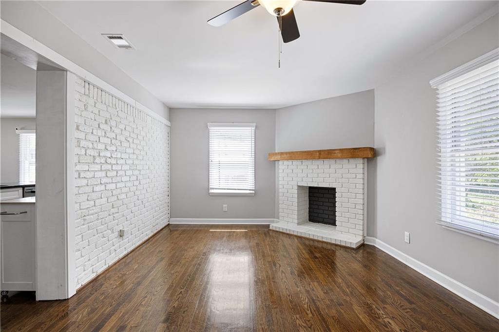 45 Smyrna Powder Springs Road Southeast Marietta, GA 30060 - Photo 17 of 45 wooden floor fireplace and windows in an empty room