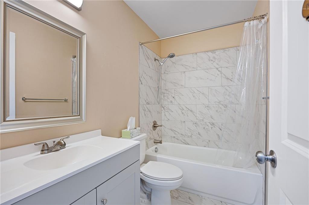 45 Smyrna Powder Springs Road Southeast Marietta, GA 30060 - Photo 20 of 45 a bathroom with a sink a toilet and a bathtub