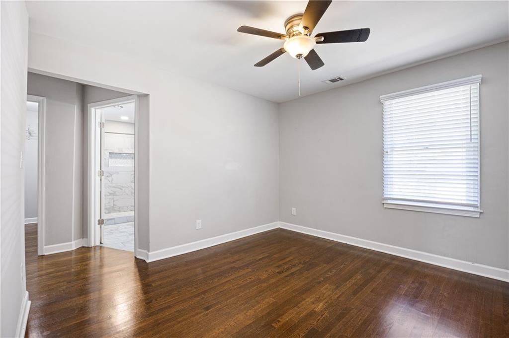 45 Smyrna Powder Springs Road Southeast Marietta, GA 30060 - Photo 23 of 45 an empty room with wooden floor fan and windows