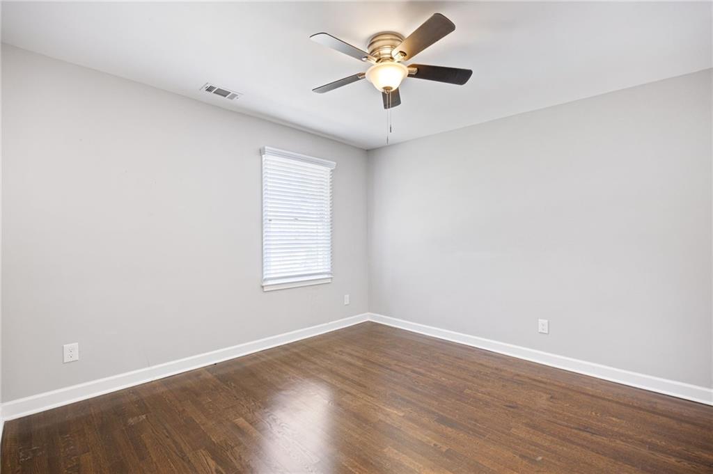 45 Smyrna Powder Springs Road Southeast Marietta, GA 30060 - Photo 24 of 45 wooden floor in an empty room with a window