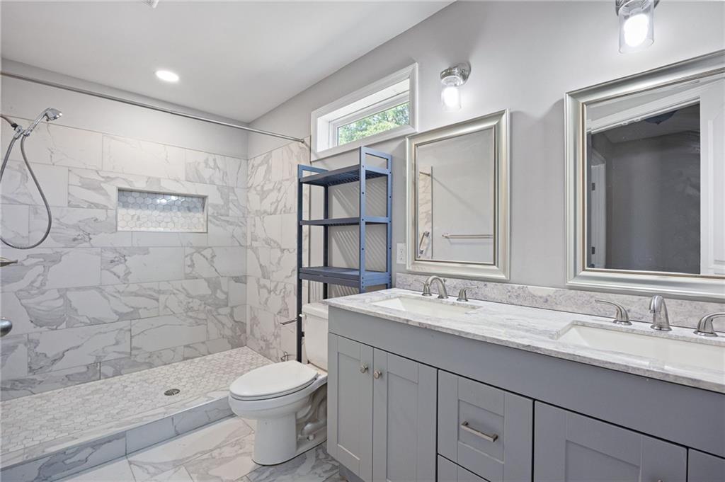 45 Smyrna Powder Springs Road Southeast Marietta, GA 30060 - Photo 25 of 45 a bathroom with a granite countertop sink toilet and shower