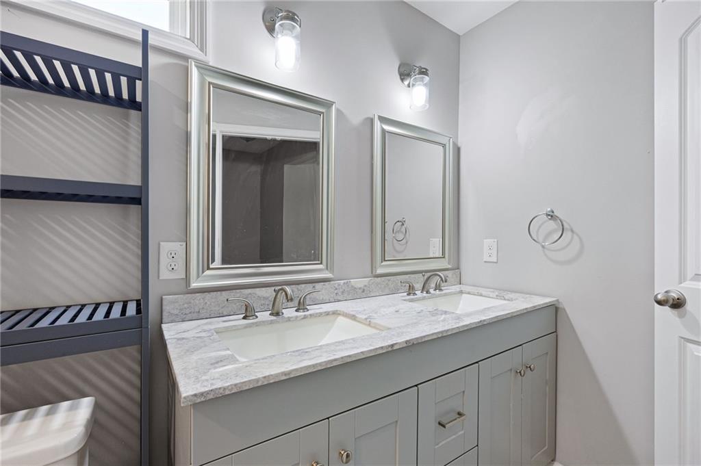 45 Smyrna Powder Springs Road Southeast Marietta, GA 30060 - Photo 26 of 45 a bathroom with a granite countertop sink and a mirror