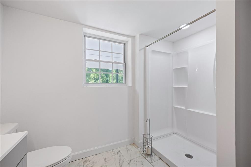 45 Smyrna Powder Springs Road Southeast Marietta, GA 30060 - Photo 31 of 45 a bathroom with a shower a toilet and a sink
