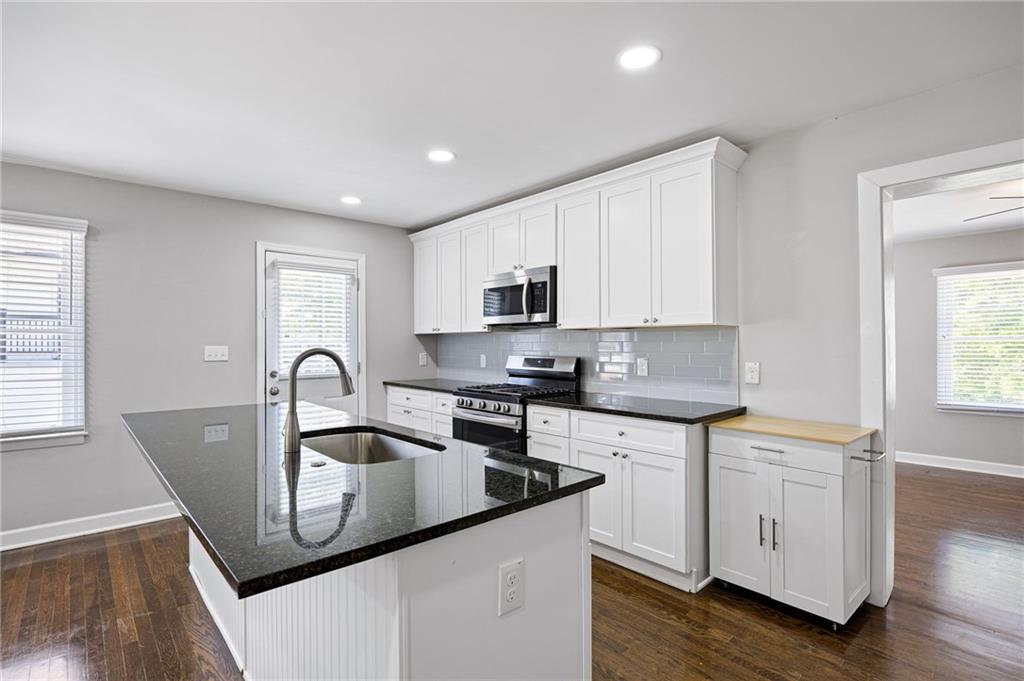 45 Smyrna Powder Springs Road Southeast Marietta, GA 30060 - Photo 10 of 45 a kitchen with stainless steel appliances granite countertop a sink a stove cabinets and wooden floor