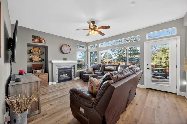 a view of a livingroom with wooden floor and furniture