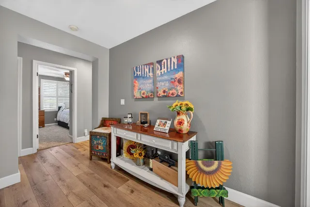 a view of entryway and hall with wooden floor