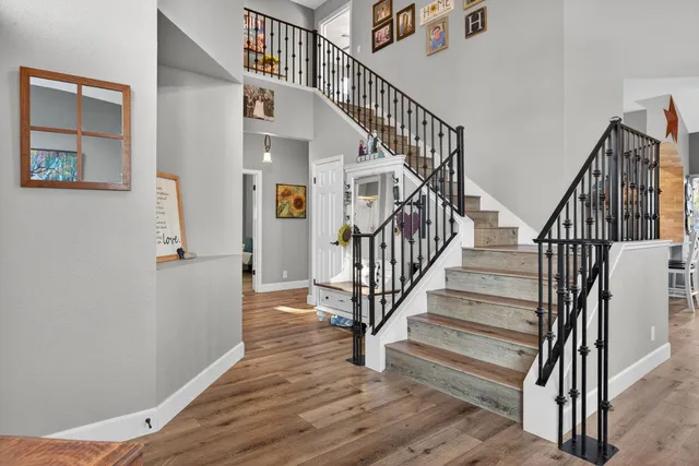 an aerial view of a house with a garden and mountain view in back