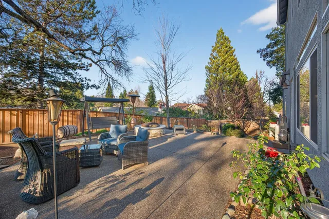 an aerial view of a house with a yard swimming pool and outdoor seating