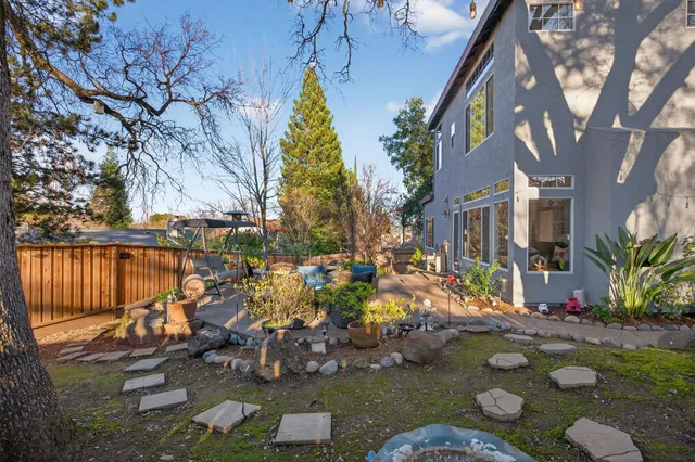 a front view of a house with a garden and patio