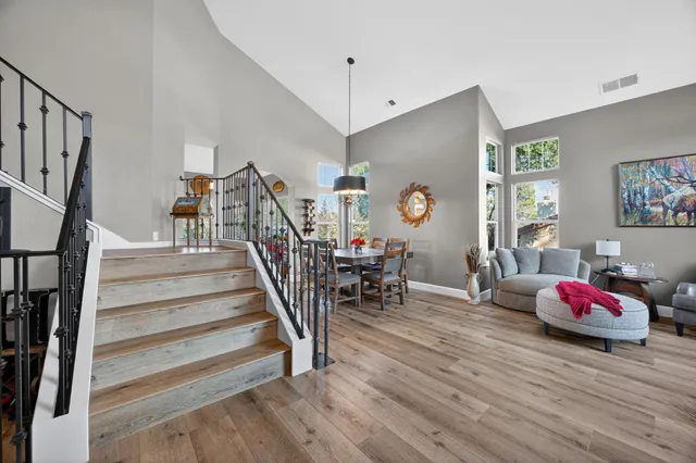 a view of a dining room with furniture and chandelier