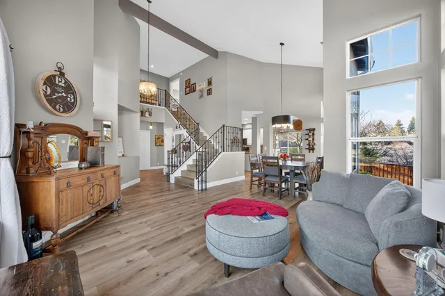 a view of a dining room with furniture a chandelier and wooden floor