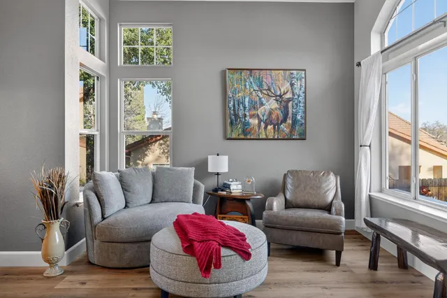 a view of a dining room with furniture a chandelier and wooden floor