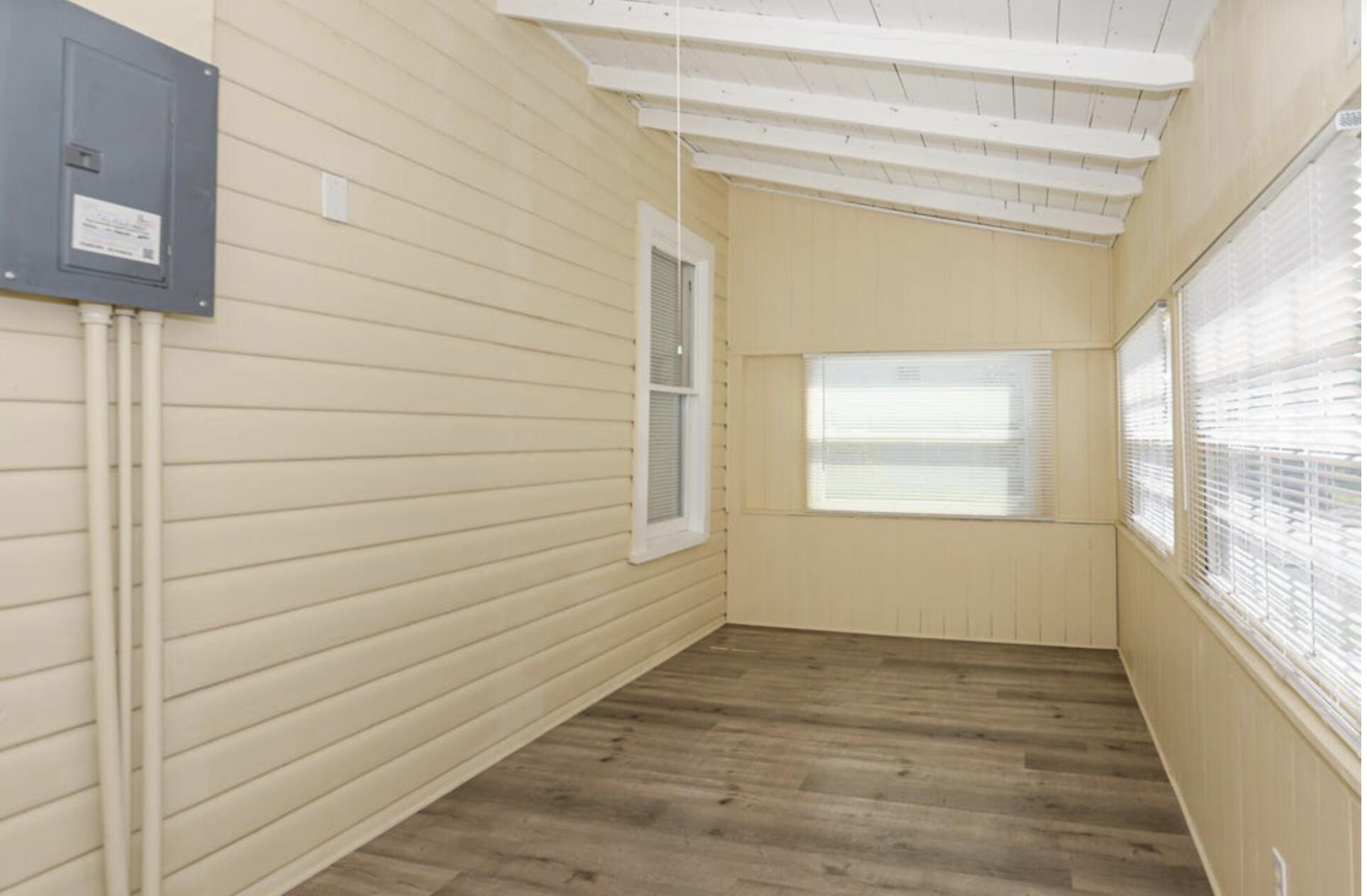 119 South 11th Street Fort Pierce, FL 34950 - Photo 13 of 22 a view of empty room with wooden floor and fan