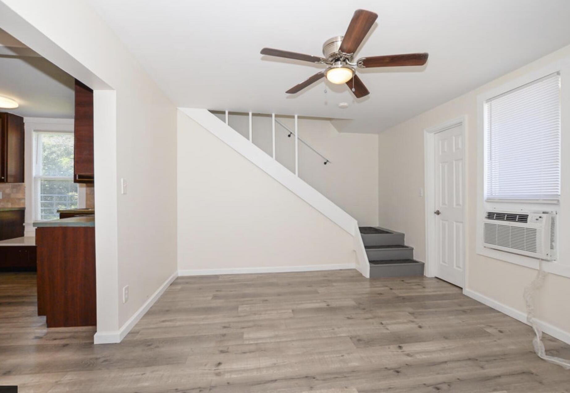 119 South 11th Street Fort Pierce, FL 34950 - Photo 14 of 22 a view of a livingroom with wooden floor stairs and a ceiling fan