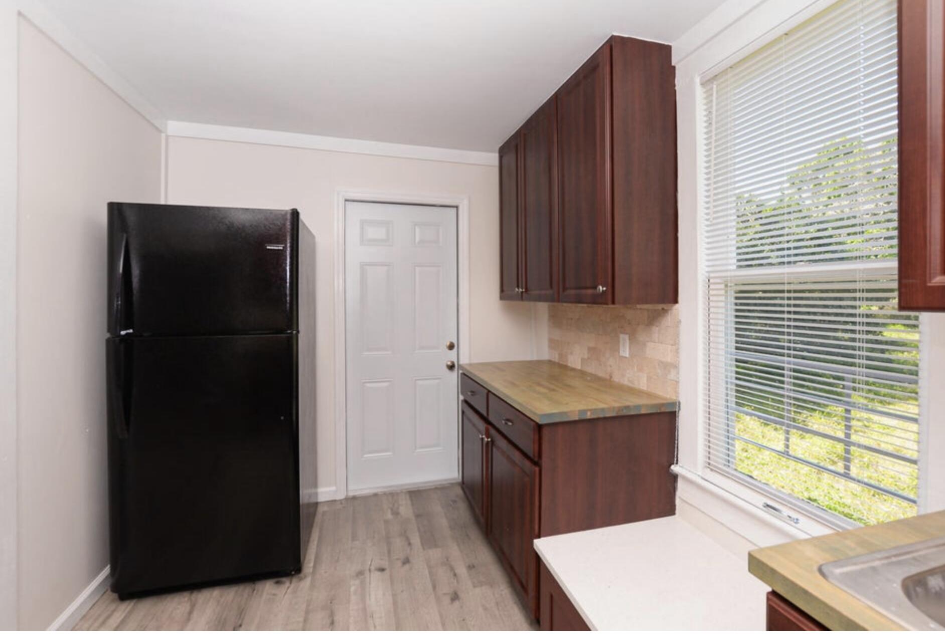 119 South 11th Street Fort Pierce, FL 34950 - Photo 19 of 22 a kitchen with a refrigerator and a window