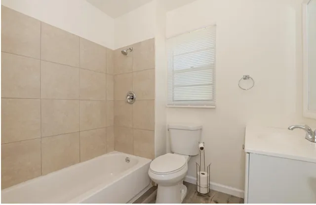 a bathroom with a toilet and shower