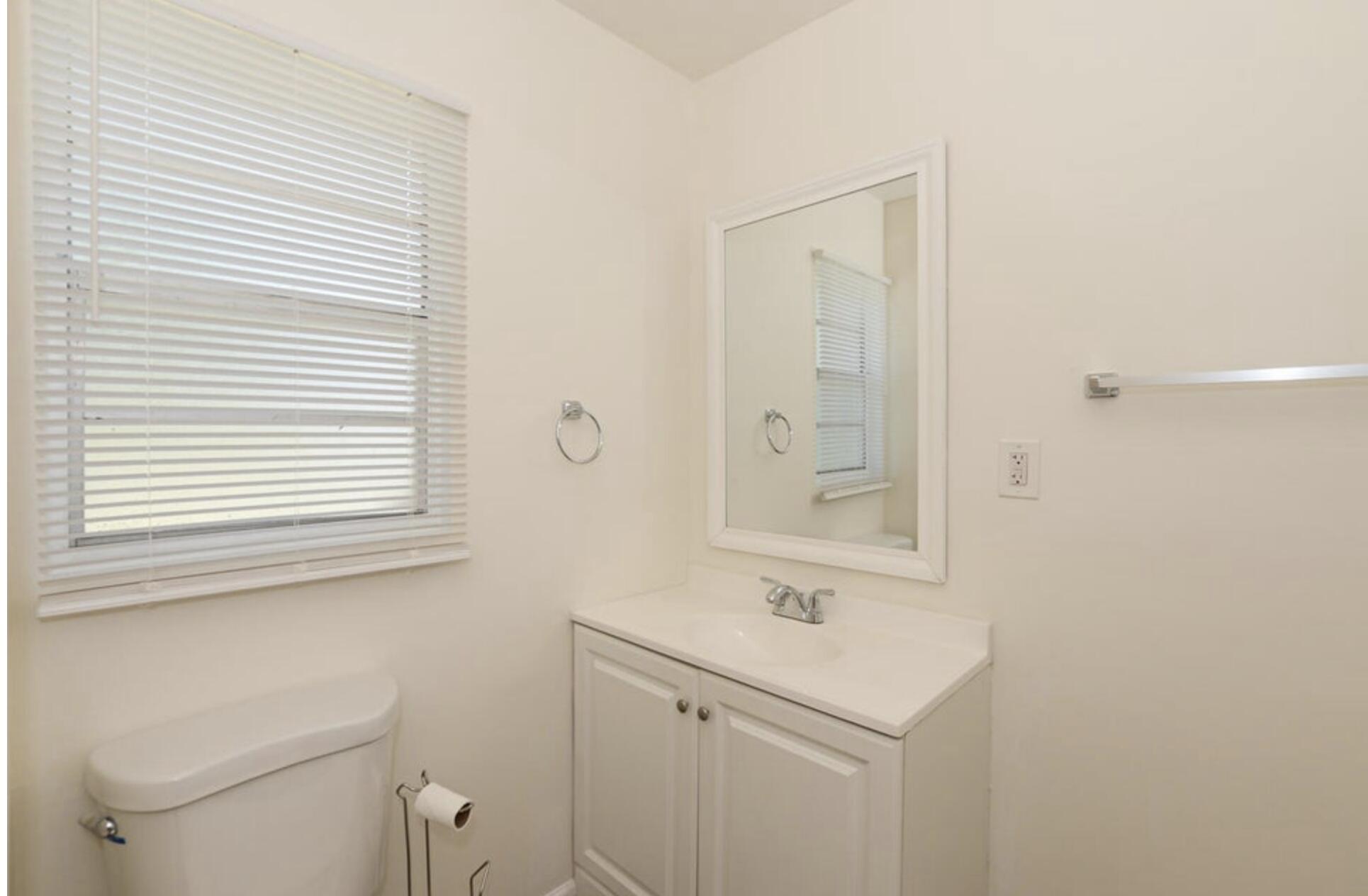 119 South 11th Street Fort Pierce, FL 34950 - Photo 8 of 22 a bathroom with a sink a toilet and a window