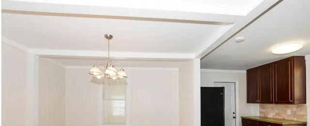 a view of a chandelier in big room with chandelier fan