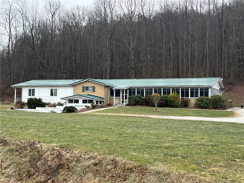 390 Mountain Road Uniontown, PA 15401 - Photo 1 of 24 a front view of a house with a garden