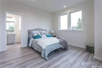 a bedroom with a bed and wooden floor
