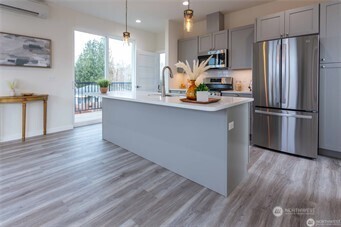 1024 North 8th Street Mount Vernon, WA 98273 - Photo 10 of 37 a kitchen with stainless steel appliances a refrigerator sink and wooden floor