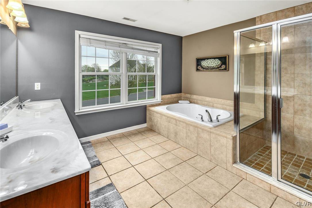 1560 Jakes Place Hellertown, PA 18055 - Photo 20 of 38 a bathroom with a tub sink and glass door shower