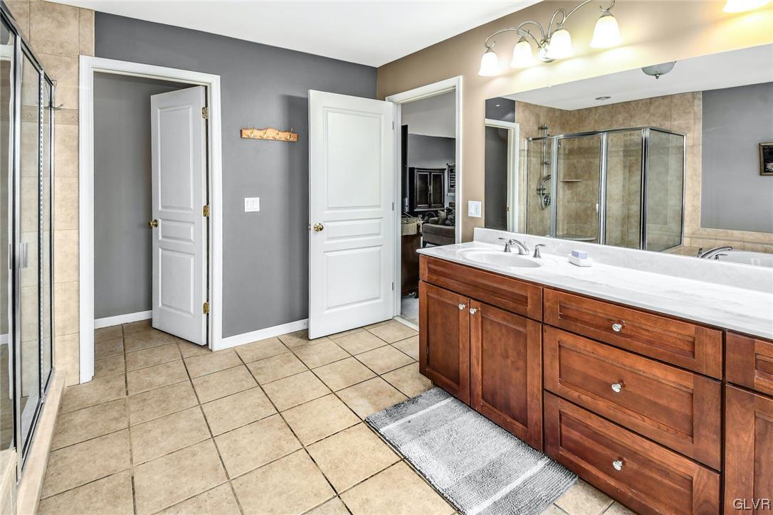 1560 Jakes Place Hellertown, PA 18055 - Photo 21 of 38 a spacious bathroom with a mirror sink and shower