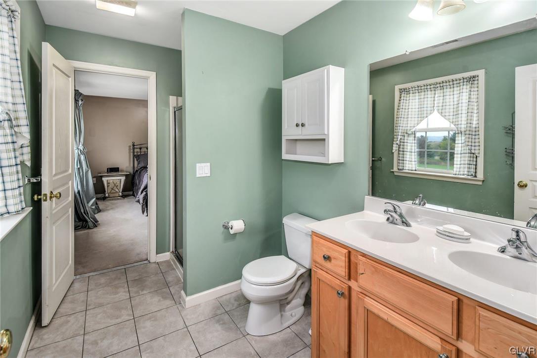 1560 Jakes Place Hellertown, PA 18055 - Photo 25 of 38 a bathroom with a sink a toilet and mirror